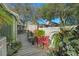 Backyard with a wooden walkway, patio seating, and beautiful array of potted plants at 628 Mount Homer Rd # 4B, Eustis, FL 32726