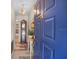Inviting entryway features wood-look flooring, a charming grandfather clock, and a striking blue front door at 628 Mount Homer Rd # 4B, Eustis, FL 32726