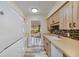 Modern kitchen with updated countertops, wood cabinets, tiled backsplash and hardwood style flooring at 628 Mount Homer Rd # 4B, Eustis, FL 32726