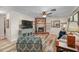 Cozy living room featuring a brick fireplace, ceiling fan, and wood flooring at 628 Mount Homer Rd # 4B, Eustis, FL 32726