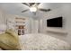 Serene main bedroom with ample closet space, a ceiling fan, and a TV mounted on the wall at 628 Mount Homer Rd # 4B, Eustis, FL 32726
