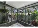 Enclosed patio with tile flooring, views of backyard, and vibrant plants, providing relaxation at 628 Mount Homer Rd # 4B, Eustis, FL 32726