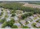 This aerial showcases lovely single-Gathering homes with mature landscaping in a desirable community near a wooded conservation area at 6410 Tildon Ct, Leesburg, FL 34748