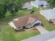 Aerial view of the home showcases lush landscaping and a manicured lawn at 6410 Tildon Ct, Leesburg, FL 34748