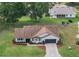 The house has a well-kept yard, beautiful plants, and a driveway at 6410 Tildon Ct, Leesburg, FL 34748