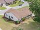 Aerial view of single-story home with brown roof, green lawn, and neatly landscaped yard in a well-maintained neighborhood at 6410 Tildon Ct, Leesburg, FL 34748