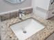Bathroom featuring a stylish granite countertop with modern faucet and a bright white sink at 6410 Tildon Ct, Leesburg, FL 34748