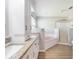 Bathroom boasting dual sinks, a large soaking tub, and a separate shower for a spa-like experience at 6410 Tildon Ct, Leesburg, FL 34748