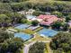 Aerial view of extensive community amenities featuring a clubhouse, pool, multiple tennis courts, and more for an active lifestyle at 6410 Tildon Ct, Leesburg, FL 34748