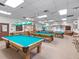 Large game room features billiard tables, neutral walls and carpet, and plenty of seating at 6410 Tildon Ct, Leesburg, FL 34748