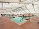 Inviting indoor pool featuring abundant natural light and comfortable deck area at 6410 Tildon Ct, Leesburg, FL 34748