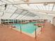 Spacious indoor pool with ample natural light and comfortable lounging areas at 6410 Tildon Ct, Leesburg, FL 34748