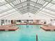 Bright indoor pool area with skylights and shallow pool marked 4 ft 6 in at 6410 Tildon Ct, Leesburg, FL 34748