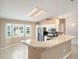 Modern kitchen with a breakfast bar, stainless steel appliances, and a bright bay window at 6410 Tildon Ct, Leesburg, FL 34748