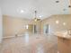 Spacious living area with tile floors, neutral walls, and a ceiling fan, perfect for relaxing or entertaining at 6410 Tildon Ct, Leesburg, FL 34748