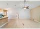 Bright open-concept living room featuring tile floors, high ceilings, and a ceiling fan at 6410 Tildon Ct, Leesburg, FL 34748