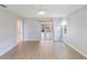 Bright, open living room featuring neutral walls, light-colored flooring, and a view to other rooms at 6410 Tildon Ct, Leesburg, FL 34748