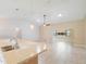 Inviting living space with tile flooring, modern lighting fixtures, and a view of the kitchen counter at 6410 Tildon Ct, Leesburg, FL 34748