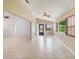 Open living area features tile flooring, many windows, and an archway at 6410 Tildon Ct, Leesburg, FL 34748
