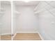 Empty walk-in closet with wire shelving on all sides providing ample storage space at 6410 Tildon Ct, Leesburg, FL 34748