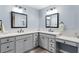 Elegant bathroom with dual sinks, stylish mirrors, and modern fixtures on light blue walls at 6444 Mcknight Loop, The Villages, FL 34762
