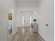 Bright entryway with light wood flooring and a decorative table creates a welcoming atmosphere at 6444 Mcknight Loop, The Villages, FL 34762