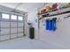 Well-lit garage with water filtration system and utility access for maintenance at 6444 Mcknight Loop, The Villages, FL 34762