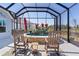 Screened-in hot tub area with stone surround and outdoor seating at 6444 Mcknight Loop, The Villages, FL 34762