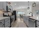 Well-equipped kitchen with stainless steel appliances, granite countertops, and adjacent dining area at 6444 Mcknight Loop, The Villages, FL 34762
