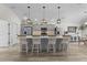 Spacious kitchen featuring a large island with seating, stainless steel appliances, and ample countertop space at 6444 Mcknight Loop, The Villages, FL 34762