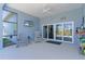 Screened lanai offers tiled flooring, ceiling fan, and access to the outdoors at 6444 Mcknight Loop, The Villages, FL 34762
