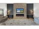 Cozy living room with a stone fireplace, modern decor, and a large area rug at 6444 Mcknight Loop, The Villages, FL 34762