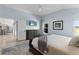 Bright main bedroom with hardwood floors, neutral walls, and an adjacent ensuite bathroom at 6444 Mcknight Loop, The Villages, FL 34762