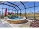 Beautiful screened-in pool with a waterfall feature, lush landscaping, and picturesque views at 6444 Mcknight Loop, The Villages, FL 34762