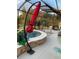 A private pool area features an umbrella for shade and seating for outdoor relaxation at 6444 Mcknight Loop, The Villages, FL 34762
