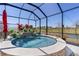 Stunning screened-in pool area with vibrant flowers, waterfall feature and peaceful views at 6444 Mcknight Loop, The Villages, FL 34762