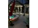 Evening view of a serene pool setting under ambient lighting and covered with a screened enclosure at 6444 Mcknight Loop, The Villages, FL 34762