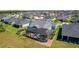 Aerial view of a home with screened-in lanai, backyard landscaping in a well maintained residential community at 6444 Mcknight Loop, The Villages, FL 34762