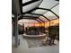 Back patio with relaxing view, featuring a luxurious round spa, complemented by ample seating and calming ambient lighting at 6444 Mcknight Loop, The Villages, FL 34762