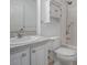 Bathroom with shower-tub combo, vanity, mirror, and storage cabinet at 701 Cottage Park Ln, Leesburg, FL 34748