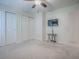 This bedroom features a TV and a closet with sliding doors at 701 Cottage Park Ln, Leesburg, FL 34748