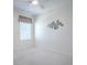 Bedroom with neutral carpet, window, and simple decor at 701 Cottage Park Ln, Leesburg, FL 34748