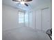 Spacious carpeted bedroom featuring a ceiling fan, window, and double closets for ample storage at 701 Cottage Park Ln, Leesburg, FL 34748