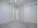 Bedroom features neutral carpet, ceiling fan, double closets, and an entry doorway at 701 Cottage Park Ln, Leesburg, FL 34748