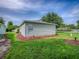 Light colored single story home with vinyl siding with view of flower beds, grass and other homes at 701 Cottage Park Ln, Leesburg, FL 34748