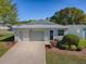 Well-maintained single-story home with a tidy front lawn and an attached single car garage at 701 Cottage Park Ln, Leesburg, FL 34748