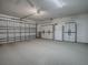 Spacious garage featuring a utility garage door at 701 Cottage Park Ln, Leesburg, FL 34748
