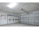 Garage with ample storage cabinets and a side-mounted garage door opener at 701 Cottage Park Ln, Leesburg, FL 34748