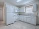 A well-maintained kitchen with white appliances, cabinets, and ample counter space at 701 Cottage Park Ln, Leesburg, FL 34748