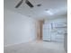 An open-concept kitchen featuring white appliances and tile flooring at 701 Cottage Park Ln, Leesburg, FL 34748